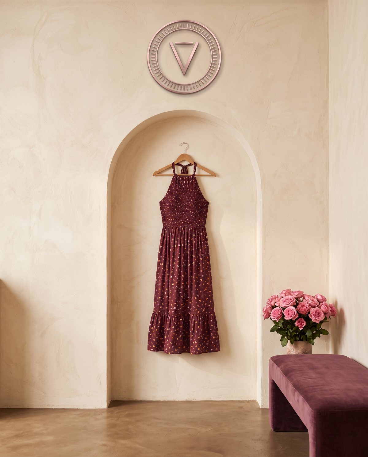 Butik Velura dengan logo Velura di dinding dan dress merah marun tergantung di ceruk lengkung